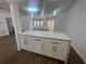 Modern kitchen featuring white cabinets, quartz countertops, and stainless steel appliances at 111 Lake Dot Dr, Sanford, FL 32773