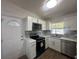 Modern kitchen with white shaker cabinets, quartz countertops and stainless steel appliances at 111 Lake Dot Dr, Sanford, FL 32773