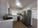 Modern kitchen with white shaker cabinets, quartz countertops and stainless steel appliances at 111 Lake Dot Dr, Sanford, FL 32773