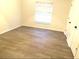 Spacious bedroom with wood-look flooring and large window at 366 Fairfield Dr, Sanford, FL 32771