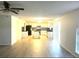 Bright living room with light wood flooring and access to the kitchen at 366 Fairfield Dr, Sanford, FL 32771