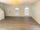 Living room with vaulted ceilings, wood-look floors, and arched windows at 366 Fairfield Dr, Sanford, FL 32771