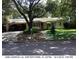 Ranch-style home with carport, mature trees, and well-maintained lawn at 2260 Hawick Ln, Winter Park, FL 32792