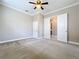 Spacious carpeted bedroom with double doors leading to bathroom and ceiling fan at 8851 Sperry St, Orlando, FL 32827