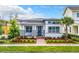 One-story home with teal front door, landscaping, and brick walkway at 8851 Sperry St, Orlando, FL 32827