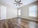 Spacious bedroom with wood-look flooring and ceiling fan at 8851 Sperry St, Orlando, FL 32827