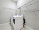 Laundry room with washer, dryer, and ample shelving at 8851 Sperry St, Orlando, FL 32827