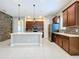 Modern kitchen with an island, stainless steel appliances, and dark wood cabinets at 8851 Sperry St, Orlando, FL 32827