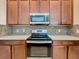 Stainless steel appliances and dark wood cabinets in a modern kitchen at 8851 Sperry St, Orlando, FL 32827