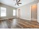 Spacious bedroom with wood-look floors and access to bathroom at 8851 Sperry St, Orlando, FL 32827
