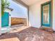 Private brick patio with teal door and wood accent wall at 8851 Sperry St, Orlando, FL 32827