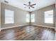 Large bedroom with wood-look floors and ceiling fan at 8851 Sperry St, Orlando, FL 32827