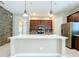 Modern kitchen with an island, stainless steel appliances, and dark wood cabinets at 8851 Sperry St, Orlando, FL 32827
