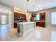 Modern kitchen with an island, stainless steel appliances, and dark wood cabinets at 8851 Sperry St, Orlando, FL 32827