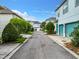 Residential alleyway with green landscaping and garages at 8851 Sperry St, Orlando, FL 32827