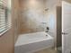 Clean bathroom with tile surround and a bathtub at 3402 Sagebrush St, Harmony, FL 34773