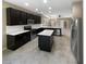 Open concept kitchen with island, stainless steel appliances, and dark cabinetry at 3402 Sagebrush St, Harmony, FL 34773
