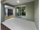 Covered back patio with sliding glass doors and neutral colored walls at 3402 Sagebrush St, Harmony, FL 34773
