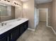 Double vanity bathroom with dark cabinets and white countertops at 3402 Sagebrush St, Harmony, FL 34773