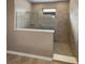 Walk-in shower with neutral tile and glass enclosure at 3402 Sagebrush St, Harmony, FL 34773