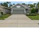 Front view of a two-car garage house with landscaping at 3402 Sagebrush St, Harmony, FL 34773