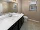 Bathroom with dark vanity, white countertop, and tile flooring at 3402 Sagebrush St, Harmony, FL 34773