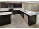 Modern kitchen with dark cabinets, white countertops, and stainless steel appliances at 3402 Sagebrush St, Harmony, FL 34773