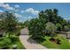 Ranch home with large trees and a paved driveway at 1281 Eastland Pt, Longwood, FL 32750