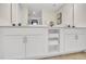 Double vanity bathroom with white cabinets and a large mirror at 4721 Clock Tower Dr # 108, Kissimmee, FL 34746
