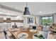 Open dining area with wooden table and modern pendant lighting at 4721 Clock Tower Dr # 108, Kissimmee, FL 34746