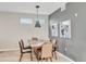 Elegant dining room with modern light fixture and gray accent wall at 4721 Clock Tower Dr # 108, Kissimmee, FL 34746