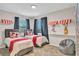 ' bedroom with twin beds, Mickey Mouse bedding, and a beanbag chair at 4721 Clock Tower Dr # 108, Kissimmee, FL 34746
