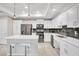 Modern kitchen with white cabinets, stainless steel appliances, and a large island at 4721 Clock Tower Dr # 108, Kissimmee, FL 34746