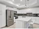 Modern kitchen with white cabinets, stainless steel appliances, and an island at 4721 Clock Tower Dr # 108, Kissimmee, FL 34746