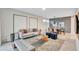 Open living and dining area with modern furnishings and large windows at 4721 Clock Tower Dr # 108, Kissimmee, FL 34746