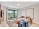 Living room with comfortable seating, large windows, and access to balcony at 4721 Clock Tower Dr # 108, Kissimmee, FL 34746