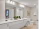 Double vanity bathroom with a large mirror and updated fixtures at 4721 Clock Tower Dr # 108, Kissimmee, FL 34746