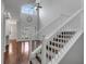 Elegant staircase with white railing and hardwood floors at 2286 Chatham Place Dr, Orlando, FL 32824