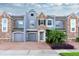Stunning three-story townhome with stone accents and two-car garage at 2286 Chatham Place Dr, Orlando, FL 32824
