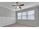 Bedroom with neutral walls, carpet flooring, wainscoting, and ceiling fan at 2286 Chatham Place Dr, Orlando, FL 32824