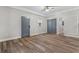 Living room with wood-look floors and multiple doors at 701 N Grandview Ave, Daytona Beach, FL 32118