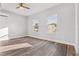 Spacious bedroom with wood-look floors and two windows at 701 N Grandview Ave, Daytona Beach, FL 32118