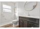 Updated bathroom with marble-look shower and vanity at 701 N Grandview Ave, Daytona Beach, FL 32118