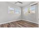 Spacious bedroom with hardwood floors and large windows offering natural light at 701 N Grandview Ave, Daytona Beach, FL 32118