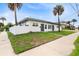 Side view of a newly renovated duplex, showcasing its landscaping and modern design at 701 N Grandview Ave, Daytona Beach, FL 32118