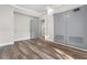 Bedroom with wood-look floors, gray doors and an open doorway at 701 N Grandview Ave, Daytona Beach, FL 32118