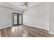 Living room with wood-look floors and french doors at 701 N Grandview Ave, Daytona Beach, FL 32118