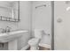 Clean bathroom with toilet, sink, shower, and linen storage at 701 N Grandview Ave, Daytona Beach, FL 32118