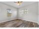 Bright bedroom with wood-look floors and two windows at 701 N Grandview Ave, Daytona Beach, FL 32118