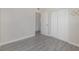 Bedroom with grey tile floors, a sliding door closet and an open doorway at 2524 Dellwood Dr, Orlando, FL 32806